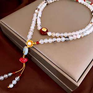 Elegant Chinese style pearl agate necklace featuring golden flower and red ruyi pendant