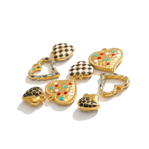 Macro shot of colorful enamel heart charms in checkered and solid gold stainless steel