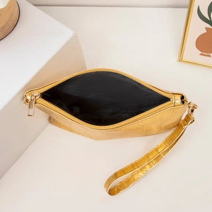 Golden crocodile texture crossbody bag with wristlet strap and metallic zipper detail