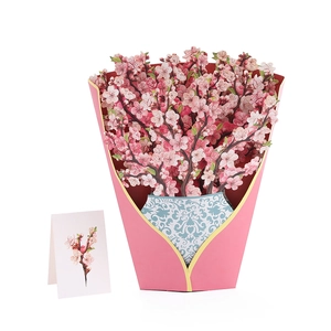 Detailed view of pink 3D pop-up cherry blossom greeting card with small gift tag