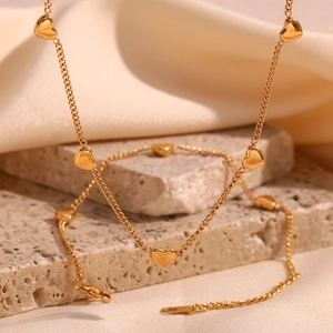 Polished 18K gold plated necklace with multiple heart pendants on a fine link chain