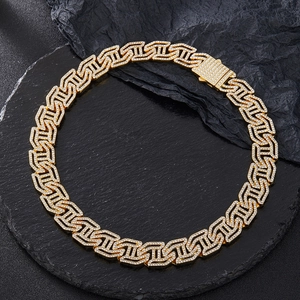 Detailed macro of golden H-link Cuban chain with sparkling white rhinestones and box clasp