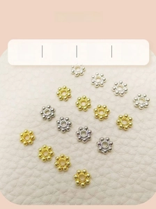 Detailed macro of 18k gold plated snowflake spacer beads for DIY jewelry making