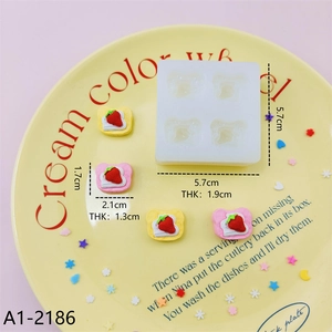 Mini bear-shaped silicone mold for DIY resin and cake baking with strawberry accents