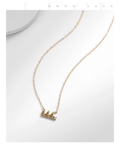 Detail of gold 444 angel number necklace with small zircon stone on a white background