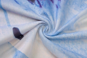 Macro shot of soft blue and white printed fabric showing smooth texture and drape