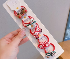 Close-up of kids Christmas hair ties set with Santa, reindeer and tree charms