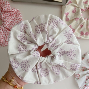 Detail of soft cotton scrunchies with purple polka dot bow and floral patterns