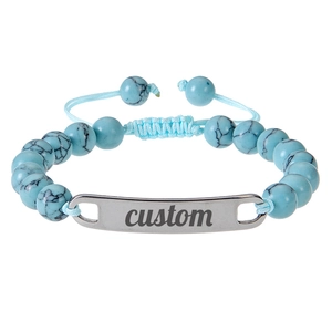 Detailed macro of turquoise style beads with adjustable light blue cord and custom silver tag