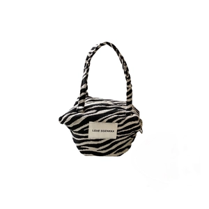 Fashionable zebra print canvas handbag with contrast pattern and top handle design