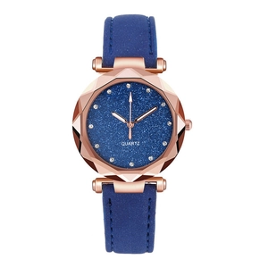 Women's quartz watch with blue starry sky dial and rose gold case on white background