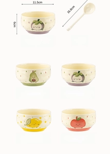 Detail of hand-painted ceramic bowls with fruit patterns and matching spoons