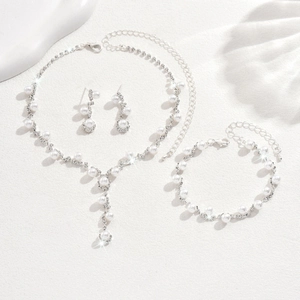 Close-up of elegant bridal jewelry set with white pearls and sparkling rhinestones