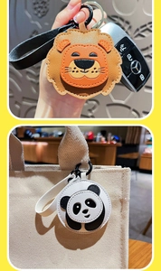 Detail of lion and panda leather keychains featuring premium stitching and metal clasps