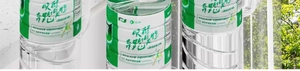 Close-up of clear plastic bottled water with green labels and marketing text on the packaging