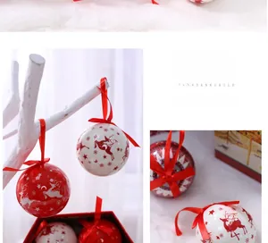 Close-up of red and white Christmas balls with reindeer and snowflake patterns