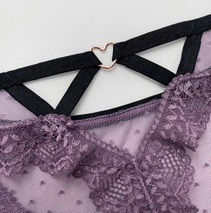 Detail of purple lace mesh underwear with polka dots and rose gold heart buckle
