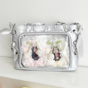 Silver satin ita bag with clear window display and decorative side ribbon bows