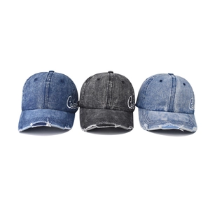 Three distressed denim baseball caps in dark blue, black grey, and light blue with embroidery
