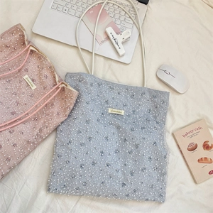 Detail of floral lace mesh tote bag with white faux pearl embroidery in pink and blue