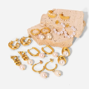 Vintage 18K gold hoop earrings set with pearls and geometric metal designs