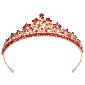 Close-up of elegant gold tiara featuring intricate red crystal gemstones for weddings