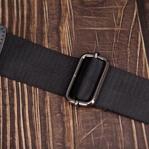 Macro detail of black high-density nylon strap with polished gunmetal adjustable buckle