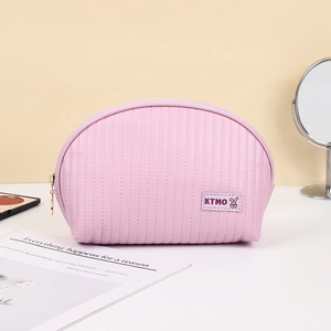 Pink shell-shaped PU leather makeup bag with quilted texture and gold zipper for travel