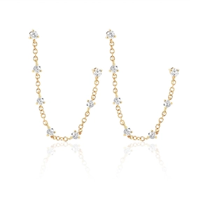Chic gold tassel earrings with zircon studs and delicate chains on a white background