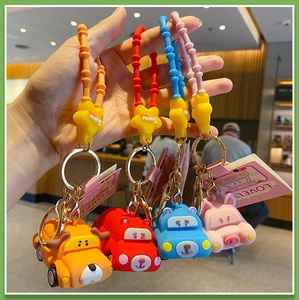 Set of four colorful silicone cartoon car keychains with wrist straps and metal rings