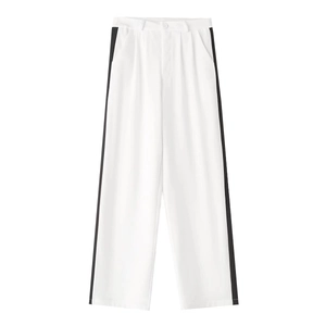 Detail of white wide-leg trousers featuring contrasting black side stripes and button waist