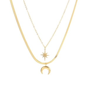 Double-layered gold necklace with celestial star and moon pendants on a flat snake chain
