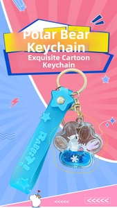 Macro detail of polar bear liquid glitter keychain with blue strap and gold hardware