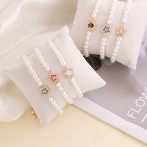 Star charm pearl bracelet with colorful sequins and zircons on white velvet padding