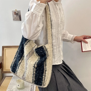 Detail of plush striped tote bag with soft texture shown in a casual lifestyle setting