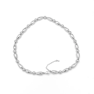 Detailed macro view of 18k silver plated beaded necklace with lobster clasp closure