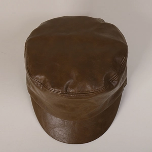 Detail of dark brown faux leather cadet cap showing premium texture and stitching