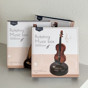 Detailed view of the rotating music box packaging for violin and lute models