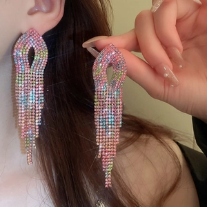 Detail of colorful gradient rhinestone tassel earrings worn showing elegant long drape