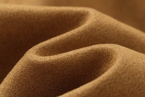 Macro view of brown suede fabric texture with soft shadows and detailed fiber finish