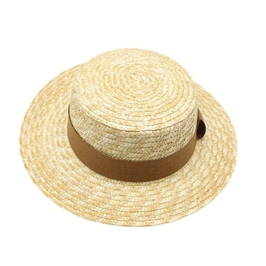 Classic woven boater straw hat with a flat top and wide brown ribbon for sun protection