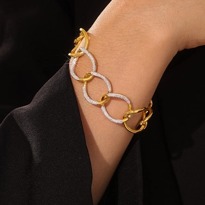 Punk style chunky gold chain bracelet with sparkling rhinestones worn on a model