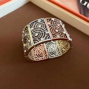 Macro shot of tricolor metallic stretch bracelet with spiral patterns and clear crystals