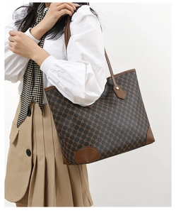 Detail of brown tote bag with vintage geometric chain pattern and leather handles