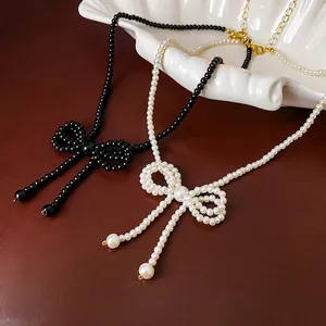 Elegant bow-knot pearl and black bead necklace with gold adjustable extension chain