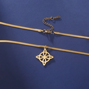 Macro detail of golden stainless steel snake chain with S.STEEL hallmark and lobster clasp
