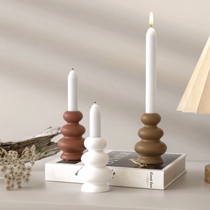 Minimalist stacked geometric candle holders in terracotta, white, and khaki resin finish