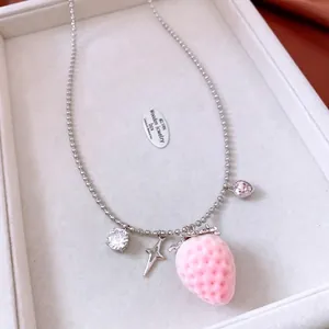 Pink strawberry pendant necklace with silver beaded chain and sparkling star charms