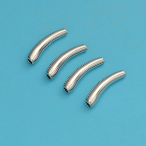 Detail view of four curved silver stainless steel tube connectors for DIY jewelry making