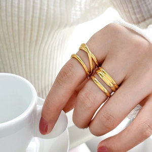 Layered 18K gold plated stainless steel knot rings set styled on fingers